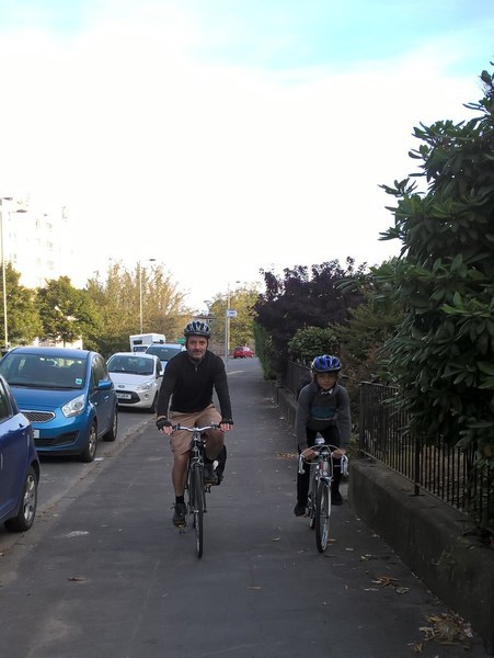 Bruce cycles with his son